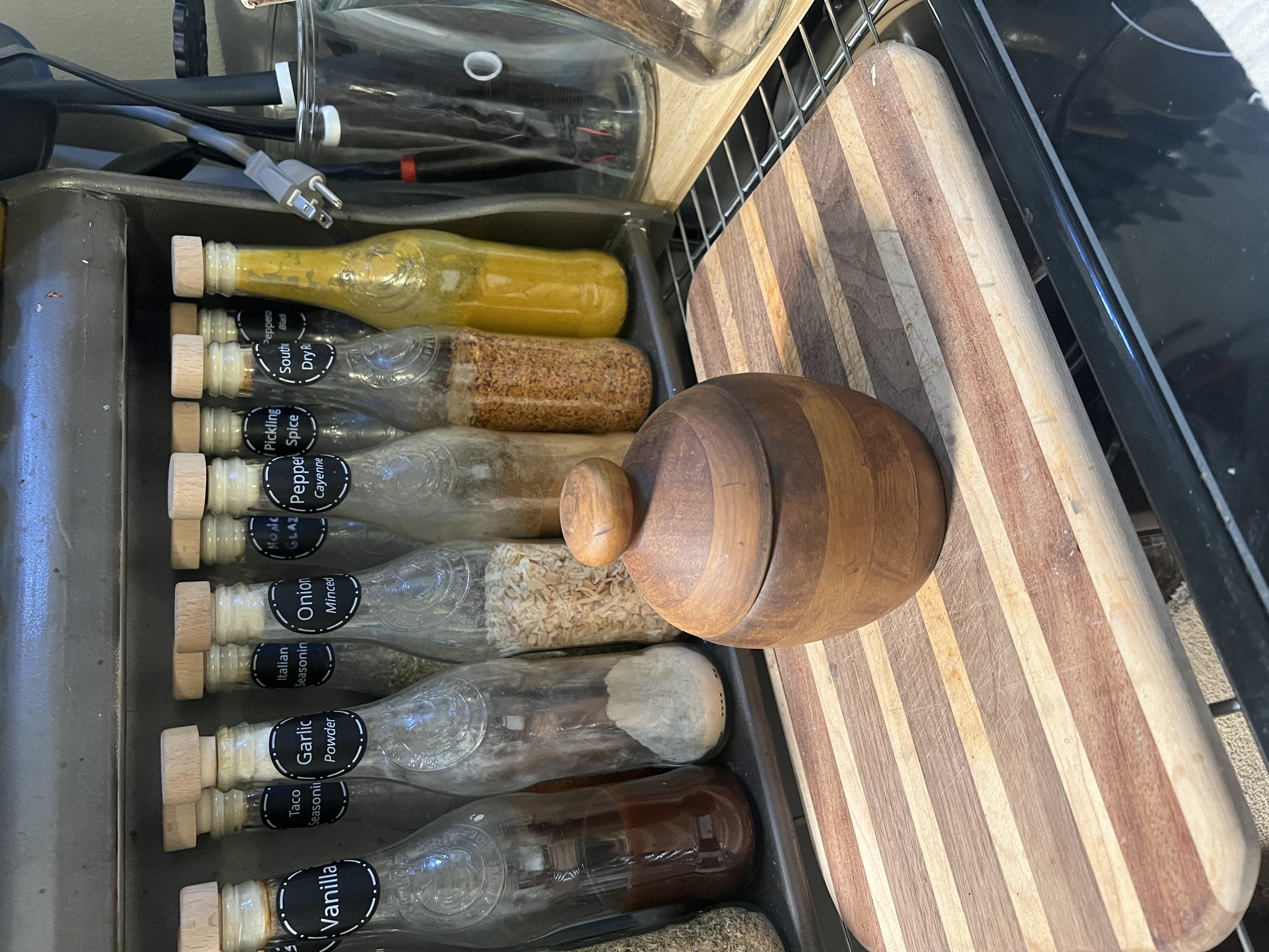A hand-turned wooden honey jar made by Robb Deignan in eighth grade, sitting on a cutting board made by his son Conner at the same age